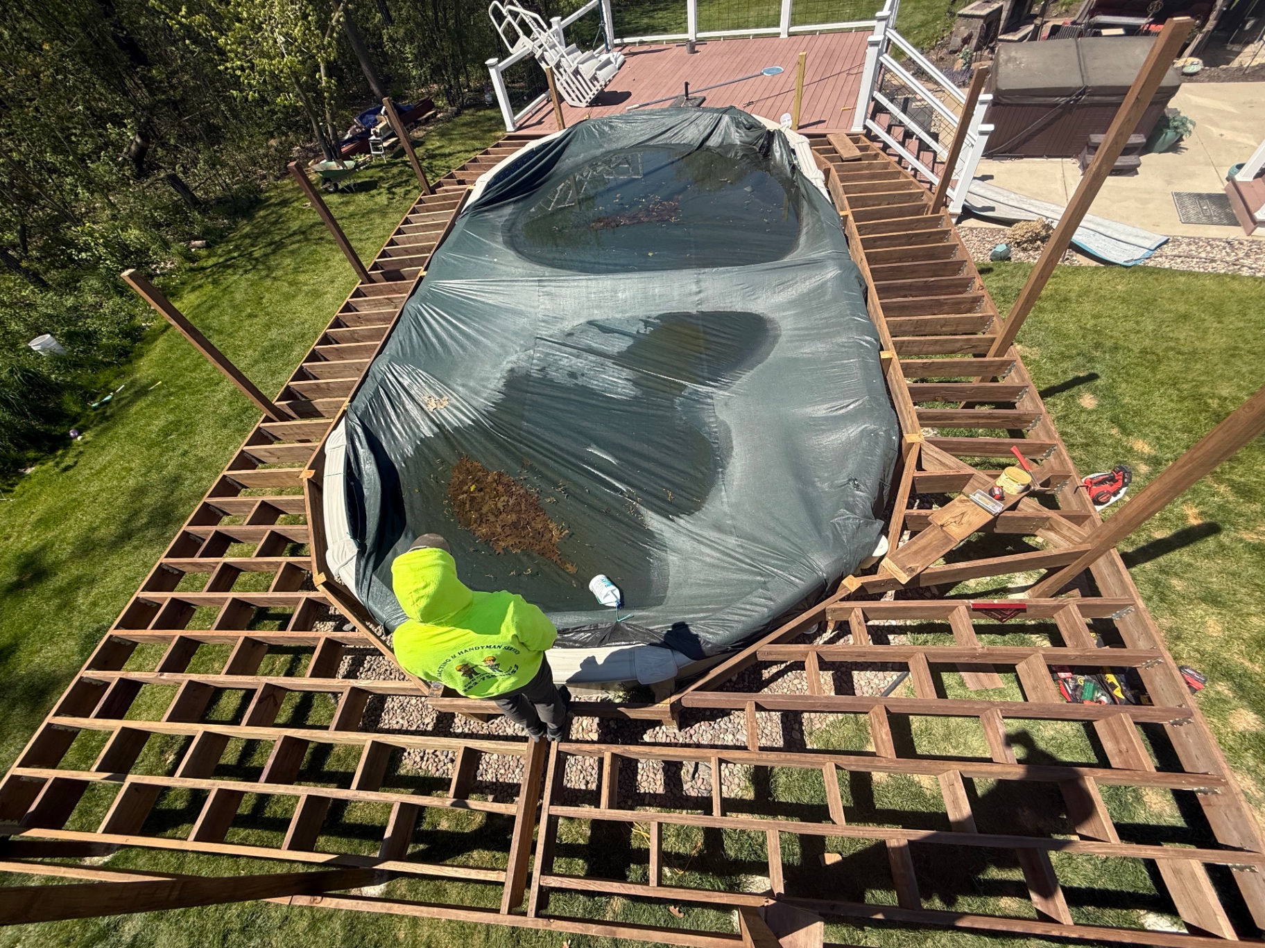 Pressure-treated deck framing around an above-ground pool