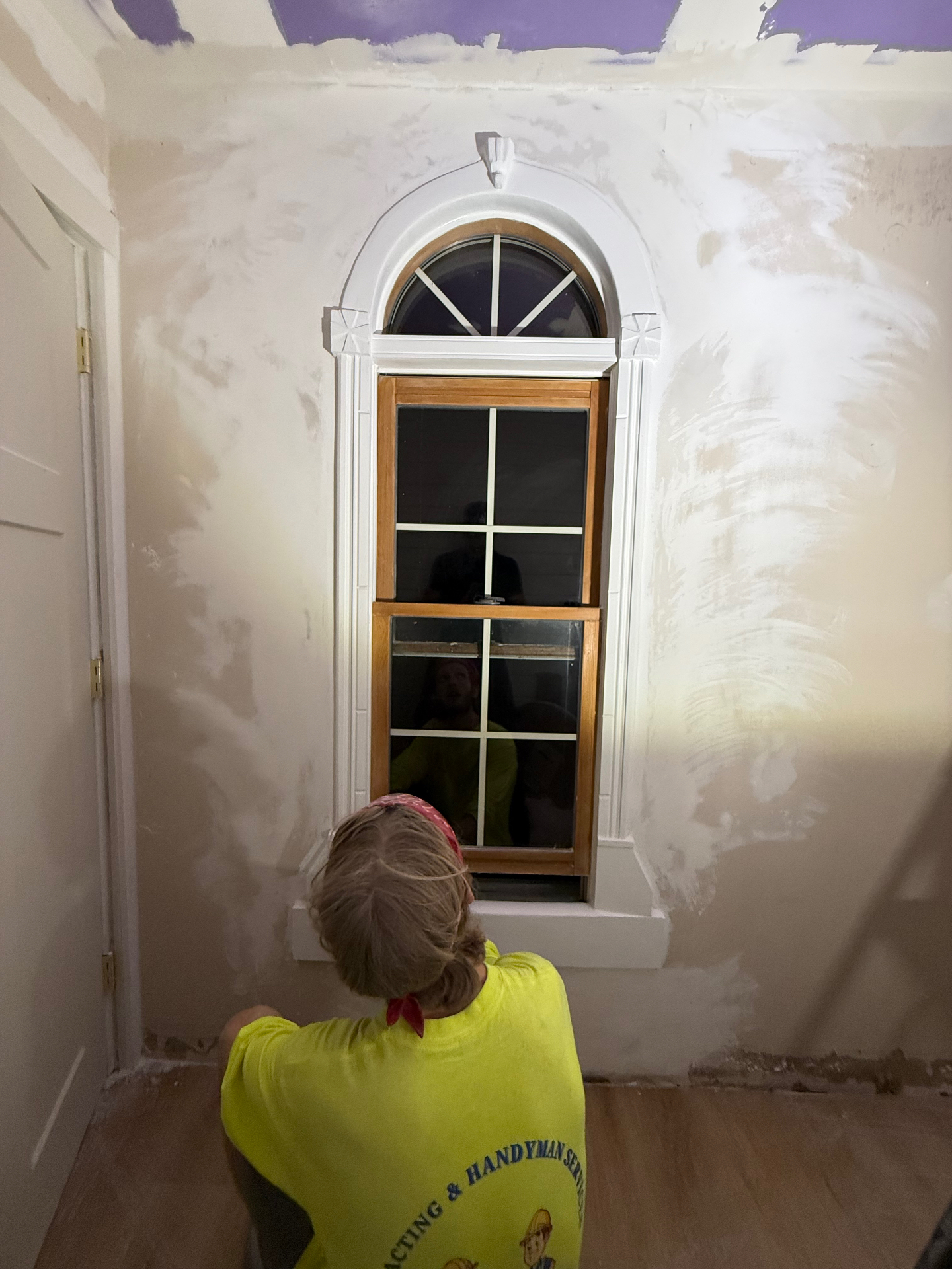 D&D Contracting owner finishing plaster and trim around an arched window